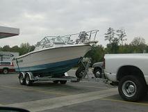 Boat secured to a tandem-axle trailer